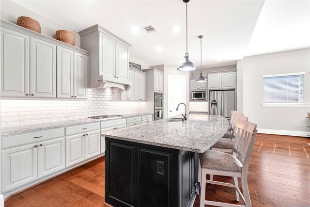 30622 Indigo Falls Dr, Brookshire, TX 77423 - kitchen featuring appliances with stainless steel finishes, a sink, wood finished floors, tasteful backsplash, and recessed lighting