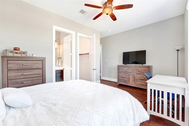 30622 Indigo Falls Dr, Fulshear, TX 77423 - bedroom with dark wood-style floors, connected bathroom, a spacious closet, and a ceiling fan