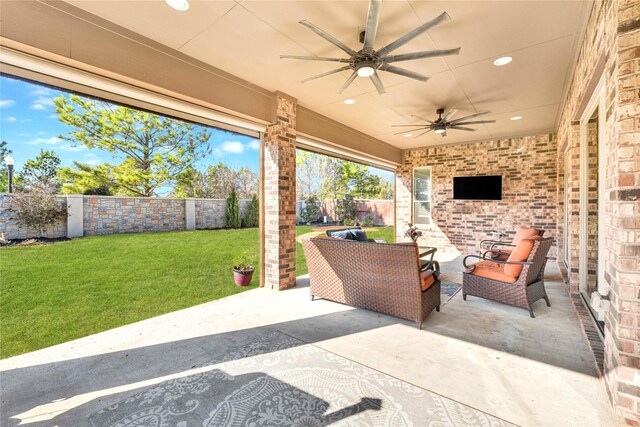 30622 Indigo Falls Dr, Fulshear, TX 77423 - fenced backyard featuring a patio area, a ceiling fan, and an outdoor hangout area