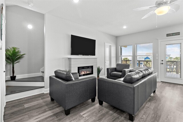 206 San Luis Blvd, Freeport, TX 77541 - living room featuring wood finished floors, a glass covered fireplace, ceiling fan, recessed lighting, and baseboards