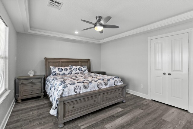206 San Luis Blvd, Freeport, TX 77541 - bedroom featuring a raised ceiling, dark wood finished floors, a closet, baseboards, and a ceiling fan
