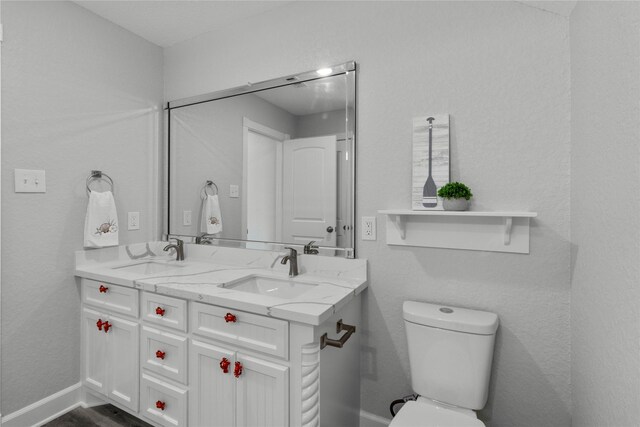 206 San Luis Blvd, Freeport, TX 77541 - bathroom featuring toilet, double vanity, and baseboards