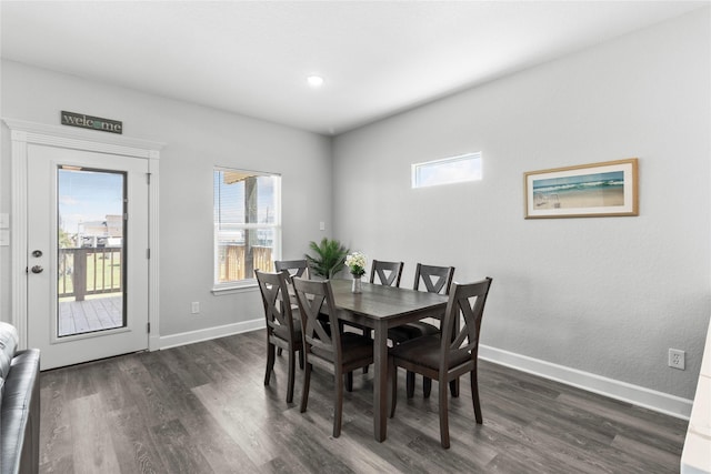 206 San Luis Blvd, Freeport, TX 77541 - dining space featuring dark wood-type flooring, baseboards, and healthy amount of natural light