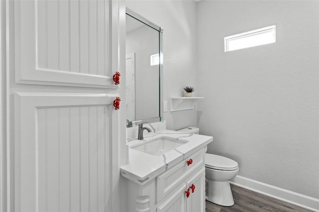 206 San Luis Blvd, Freeport, TX 77541 - bathroom with wood finished floors, baseboards, vanity, and toilet