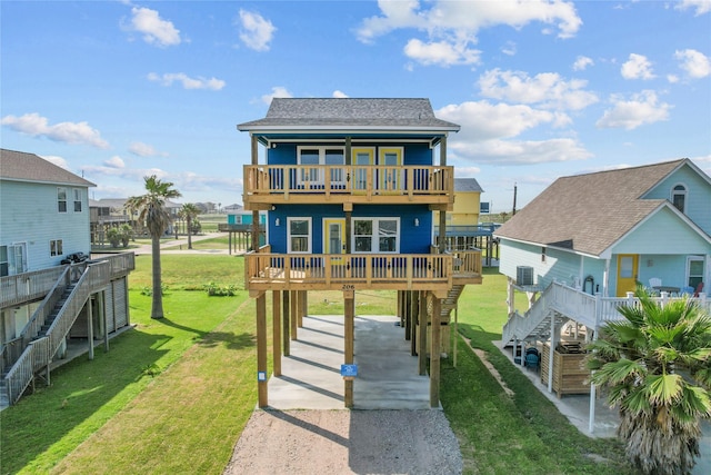 206 San Luis Blvd, Freeport, TX 77541 - rear view of house with driveway, stairs, a carport, and a yard