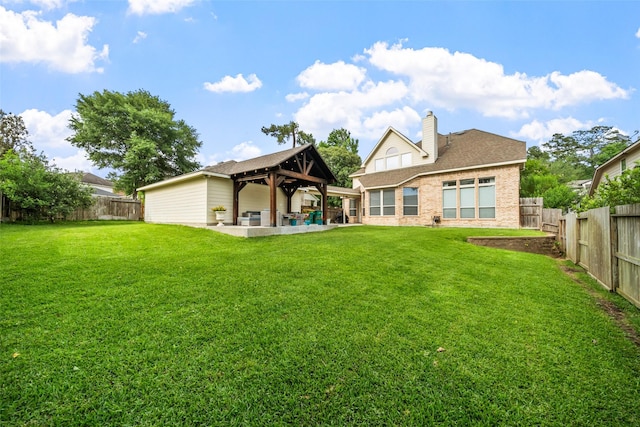 2510 Eagle Post Dr, Conroe, TX 77304 - back of property featuring a gazebo, a chimney, brick siding, and a patio area