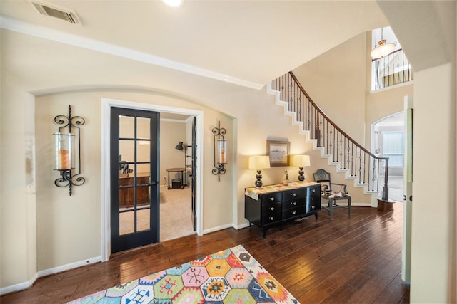 2510 Eagle Post Dr, Conroe, TX 77304 - entryway with dark wood-type flooring, baseboards, stairs, arched walkways, and french doors
