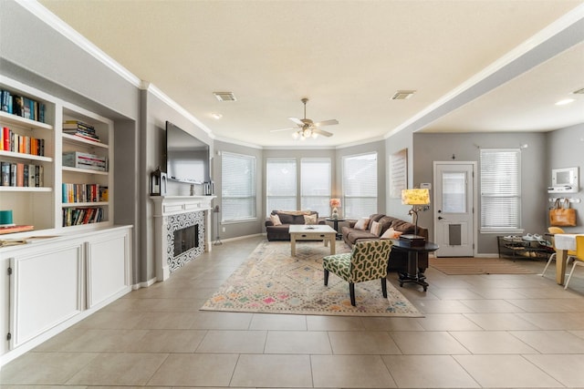 2510 Eagle Post Dr, Conroe, TX 77304 - living room with crown molding, plenty of natural light, light tile patterned floors, a ceiling fan, and a fireplace
