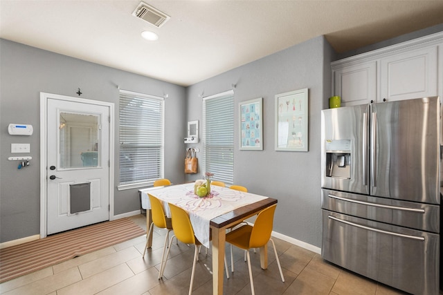 2510 Eagle Post Dr, Conroe, TX 77304 - dining space with baseboards and light tile patterned flooring