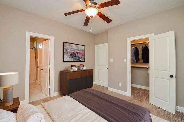 705 Seydler St, East Bernard, TX 77435 - bedroom featuring a walk in closet, light colored carpet, baseboards, a closet, and connected bathroom