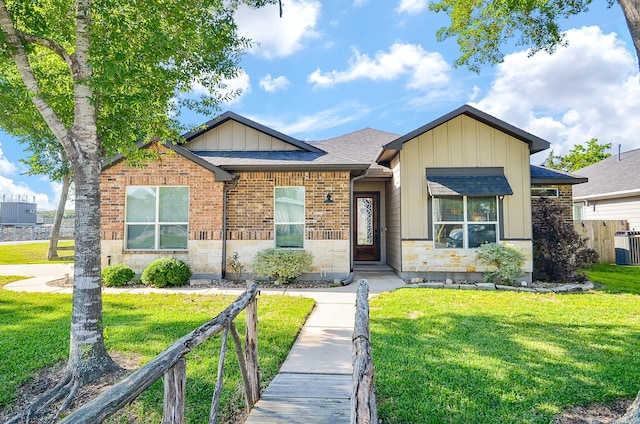 705 Seydler St, East Bernard, TX 77435 - view of front of home featuring board and batten siding, brick siding, roof with shingles, and stone siding