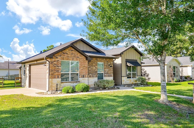 705 Seydler St, East Bernard, TX 77435 - view of front facade featuring board and batten siding, concrete driveway, a front lawn, a garage, and stone siding