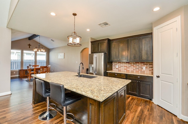 705 Seydler St, East Bernard, TX 77435 - kitchen featuring stainless steel fridge with ice dispenser, a sink, dark wood finished floors, light stone countertops, and recessed lighting