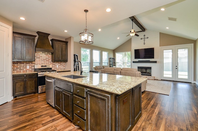 705 Seydler St, East Bernard, TX 77435 - kitchen featuring appliances with stainless steel finishes, a sink, dark wood-type flooring, dark brown cabinets, and beamed ceiling