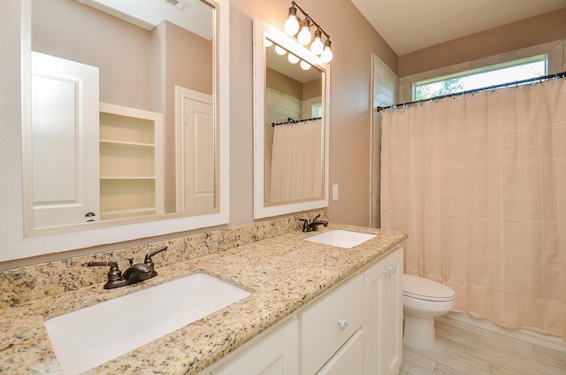 705 Seydler St, East Bernard, TX 77435 - full bath with toilet, double vanity, a shower with curtain, and wood finished floors