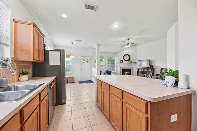 10826 Redstone Ct, Missouri City, TX 77459 - kitchen featuring a sink, ceiling fan, a lit fireplace, light countertops, and recessed lighting