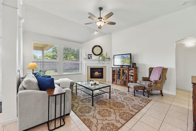 10826 Redstone Ct, Missouri City, TX 77459 - living area featuring arched walkways, ornamental molding, ceiling fan, light tile patterned floors, and a tile fireplace