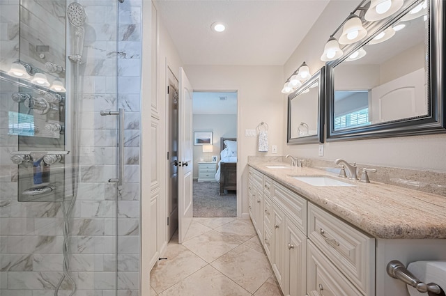 bathroom featuring connected bathroom, double vanity, tiled shower, tile patterned floors, and recessed lighting