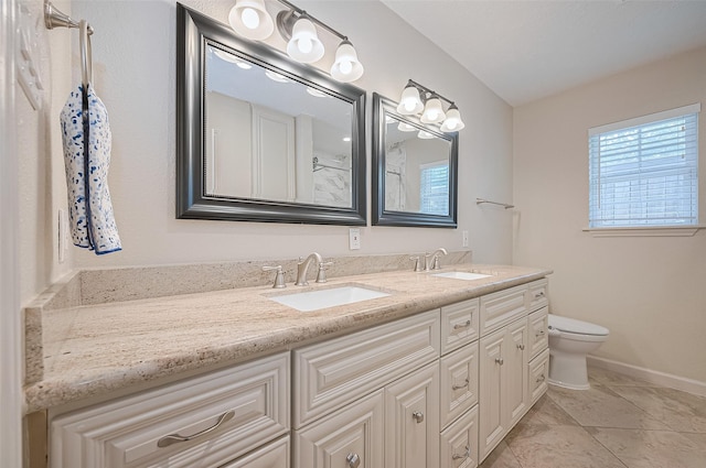 full bathroom with toilet, double vanity, baseboards, and tile patterned floors