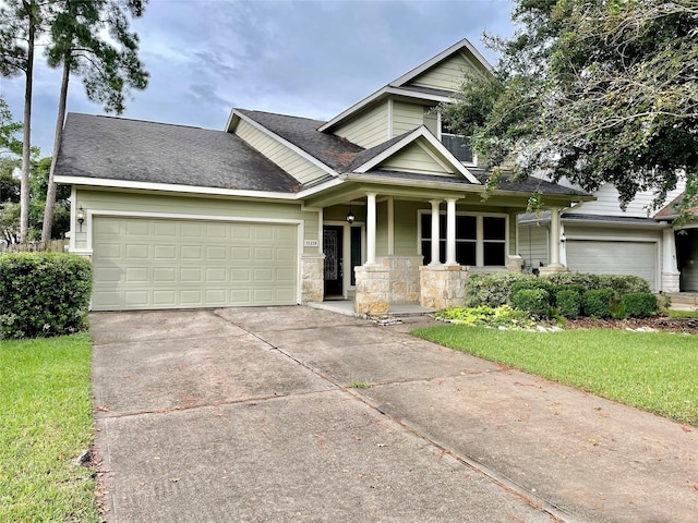 15238 Ledgewood Park Dr, Cypress, TX 77429 - view of front of house with an attached garage, covered porch, concrete driveway, a front lawn, and a shingled roof