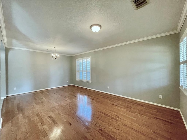 15238 Ledgewood Park Dr, Cypress, TX 77429 - unfurnished room featuring a chandelier, wood finished floors, ornamental molding, baseboards, and a textured ceiling