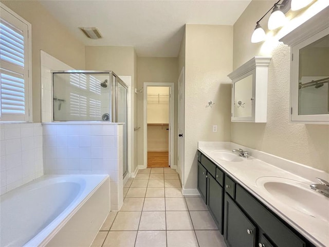 15238 Ledgewood Park Dr, Cypress, TX 77429 - full bathroom featuring a stall shower, a garden tub, a walk in closet, tile patterned floors, and double vanity