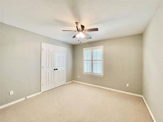 15238 Ledgewood Park Dr, Cypress, TX 77429 - unfurnished bedroom featuring light colored carpet, baseboards, a closet, and a ceiling fan