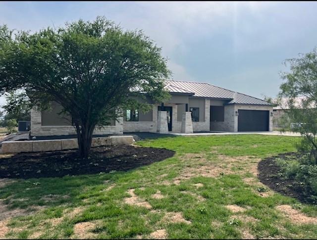 1463 Mountain Valley Dr, Concan, TX 78838 - view of front of property featuring a garage, a front yard, and metal roof