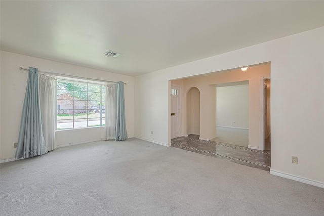 7827 Braesdale Ln, Houston, TX 77071 - empty room with arched walkways, carpet flooring, and baseboards