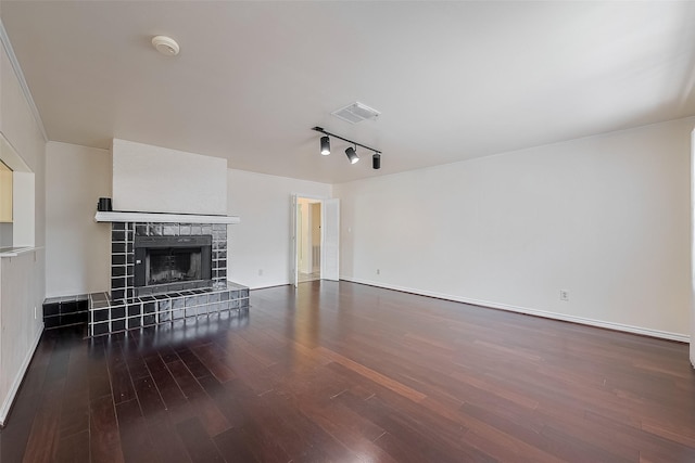 7827 Braesdale Ln, Houston, TX 77071 - unfurnished living room with wood finished floors, a fireplace, rail lighting, and baseboards