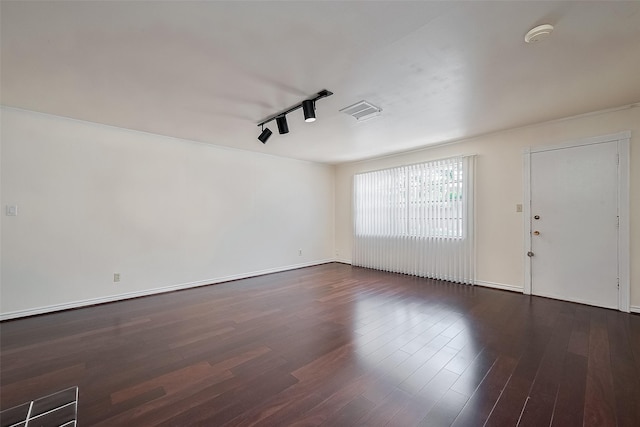 7827 Braesdale Ln, Houston, TX 77071 - unfurnished room featuring track lighting, dark wood-type flooring, and baseboards