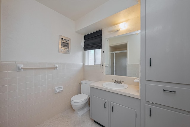 7827 Braesdale Ln, Houston, TX 77071 - bathroom with tile walls, a stall shower, toilet, vanity, and wainscoting