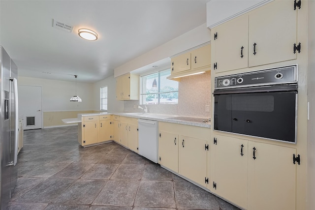 7827 Braesdale Ln, Houston, TX 77071 - kitchen featuring black appliances, cream cabinets, light countertops, a peninsula, and tasteful backsplash