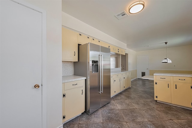 7827 Braesdale Ln, Houston, TX 77071 - kitchen featuring stainless steel fridge with ice dispenser, light countertops, cream cabinets, and decorative light fixtures