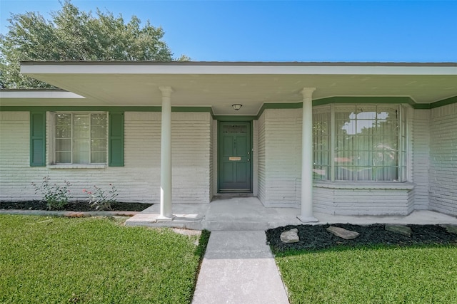7827 Braesdale Ln, Houston, TX 77071 - entrance to property featuring brick siding, covered porch, and a lawn