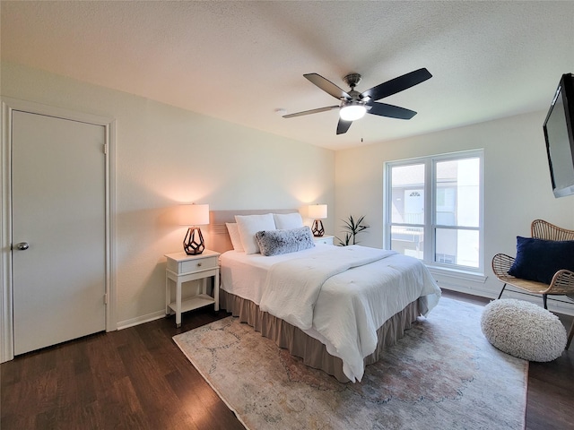 1201 Bering Dr Unit 44, Houston, TX 77057 - bedroom featuring dark wood-style flooring, a ceiling fan, and baseboards