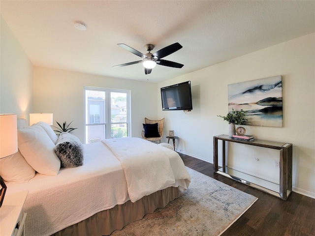 1201 Bering Dr Unit 44, Houston, TX 77057 - bedroom with baseboards, dark wood-type flooring, and a ceiling fan