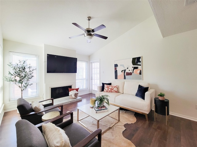 1201 Bering Dr Unit 44, Houston, TX 77057 - living room with vaulted ceiling, wood finished floors, ceiling fan, baseboards, and a tiled fireplace