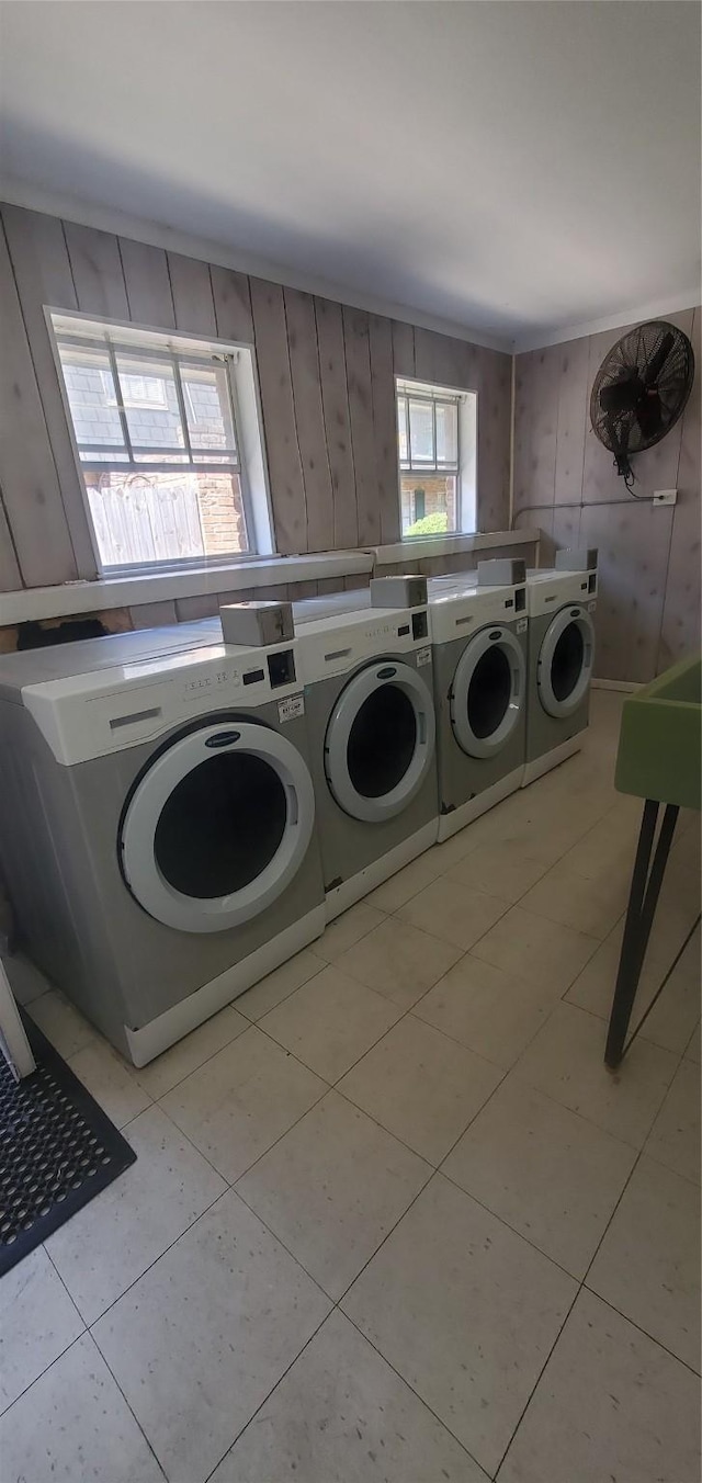 8941 Gaylord St Unit 211, Houston, TX 77024 - community laundry featuring washer and clothes dryer, wooden walls, and light tile patterned floors