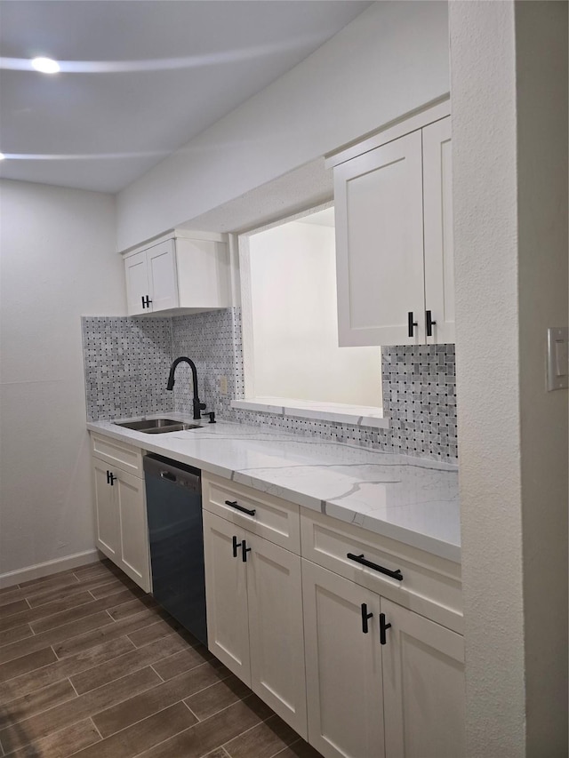 8941 Gaylord St Unit 211, Houston, TX 77024 - kitchen with black dishwasher, a sink, decorative backsplash, white cabinetry, and dark wood-type flooring