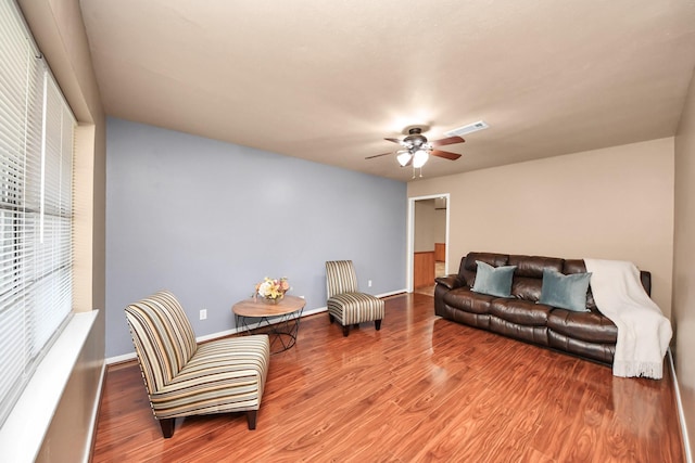 730 Columbia Ln, Deer Park, TX 77536 - living room featuring a ceiling fan, wood finished floors, and baseboards