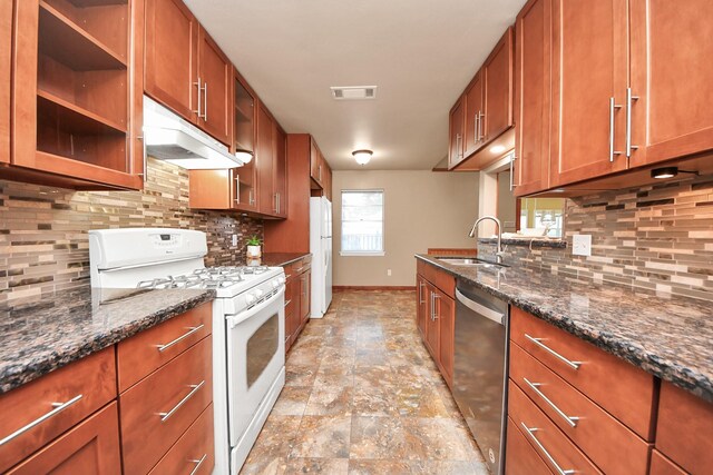 730 Columbia Ln, Deer Park, TX 77536 - kitchen with white appliances, a sink, under cabinet range hood, light stone finish floors, and baseboards