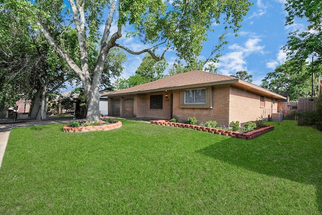 730 Columbia Ln, Deer Park, TX 77536 - view of front of home featuring brick siding, a garage, central AC unit, and driveway