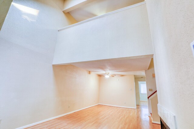 2425 Holly Hall St Unit 149, Houston, TX 77054 - empty room featuring wood finished floors, a ceiling fan, stairs, and baseboards