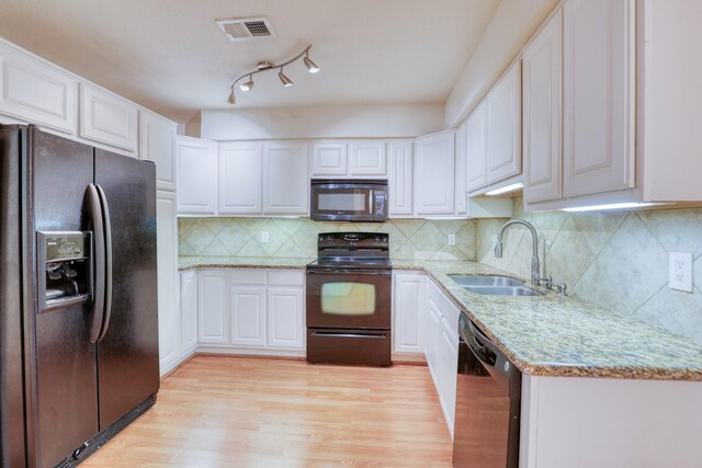 2425 Holly Hall St Unit 149, Houston, TX 77054 - kitchen featuring black appliances, a sink, light wood-style flooring, white cabinetry, and light stone counters