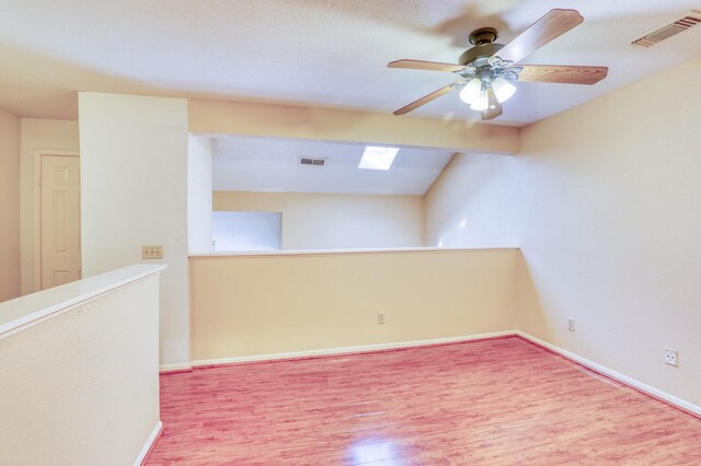 2425 Holly Hall St Unit 149, Houston, TX 77054 - empty room featuring wood finished floors, a ceiling fan, baseboards, and a skylight