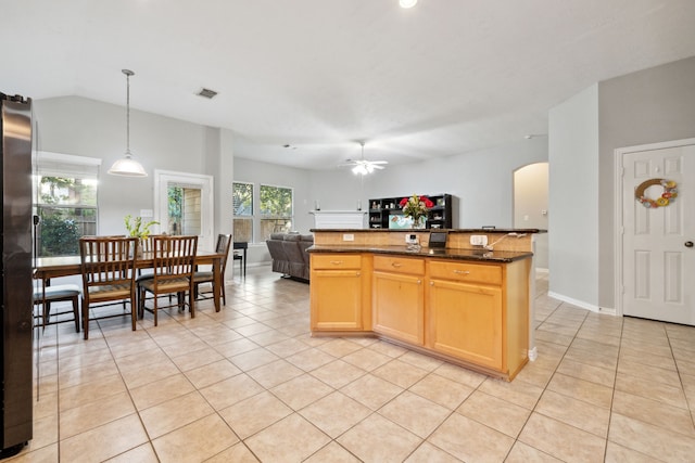 18011 Outback Lakes Trl, Humble, TX 77346 - kitchen featuring arched walkways, light tile patterned floors, ceiling fan, open floor plan, and hanging light fixtures