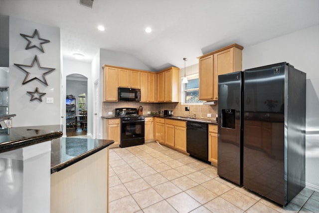 18011 Outback Lakes Trl, Humble, TX 77346 - kitchen featuring black appliances, arched walkways, vaulted ceiling, tasteful backsplash, and light tile patterned floors