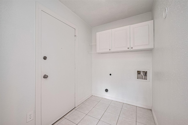 7011 Maple Fox Dr, Humble, TX 77338 - laundry room with cabinet space, washer hookup, electric dryer hookup, light tile patterned floors, and baseboards