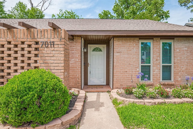 7011 Maple Fox Dr, Humble, TX 77338 - doorway to property with brick siding and a shingled roof